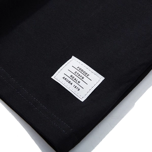 Men's loose black jogger shorts featuring detailed brand woven label and stitching