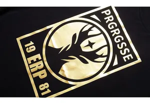Close-up of metallic gold graphic print with deer silhouette on black t-shirt chest