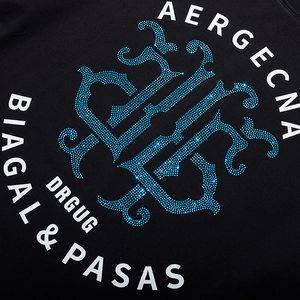 Black cotton t-shirt featuring blue rhinestones and white logo print in close-up view