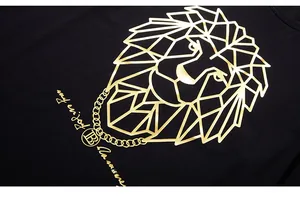 Close-up of golden geometric lion print with B-logo on black cotton t-shirt