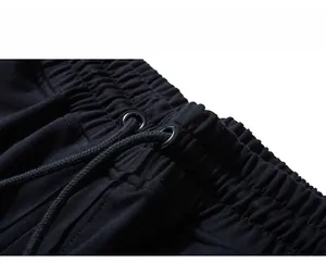 Close-up of elastic waistband with black drawstrings and metal eyelets on sports shorts