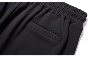 Detail shot of men's sports joggers showing elastic waistband and back welt pocket