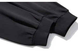 Detailed macro view of black ribbed ankle cuffs on minimalist sports sweatpants