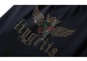 Détail de la couronne en strass et lettrage gothique sur short en coton noir