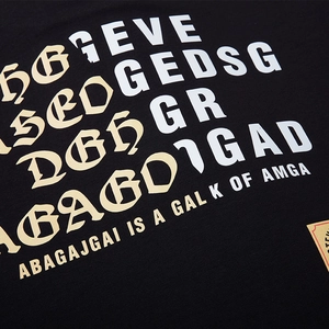 Oversized black cotton T-shirt featuring bold gothic and sans-serif letter prints