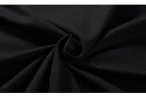 Macro detail of high-quality black cotton knitted fabric showing texture and softness