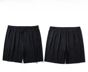 Front and back view of men's casual sports shorts with textured fabric and drawstring