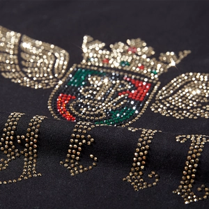 Black cotton t-shirt with detailed rhinestone crown shield emblem and colorful accents