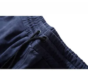 Detail view of navy sports shorts showing elastic waistband with black braided drawstring