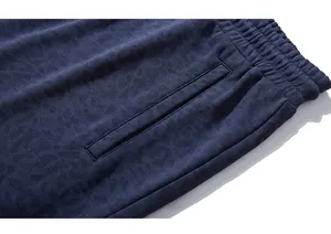 Detail of dark blue sweat shorts featuring leopard jacquard pattern and elastic waistband