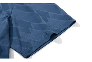 Detail of navy blue quick-dry fabric with breathable mesh texture and geometric patterns