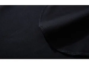 Macro view of tight knit texture and high-quality stitched hem on black sports shorts