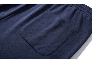 Detail of navy blue leisure shorts with subtle leopard jacquard pattern and rear pocket