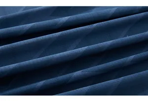 Macro shot of dark blue quick-dry fabric with breathable micro-holes and geometric patterns