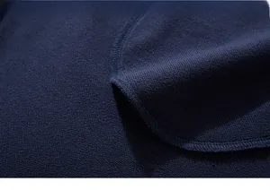Macro shot of dark blue terry cloth fabric showing premium knitting and edge stitching