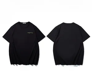 Close-up of embroidered yellow lettering on the chest of a black cotton t-shirt