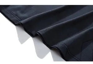 Macro detail of dark grey quick-dry fabric with breathable micro-pores and geometric patterns