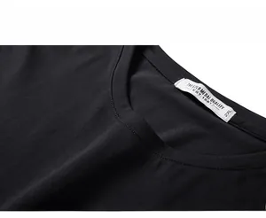 Detail of crew neckline on a black 2XL cotton t-shirt showing the quality size label