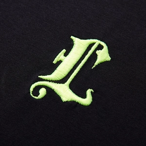 Oversized black cotton T-shirt featuring large 3D neon green Gothic L letter embroidery
