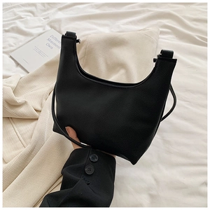 Gros plan sur le cuir noir grainé d'un sac hobo élégant avec texture lychee