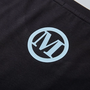 Oversized black cotton T-shirt featuring a light blue circular M letter print detail