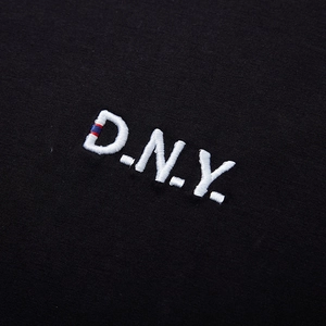 Oversized black cotton T-shirt featuring high-density D.N.Y. white embroidery on the chest