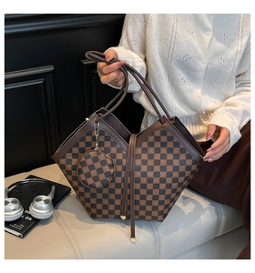 Detail of checkered bucket bag with matching round coin purse and metal chain link