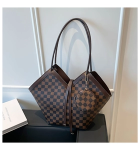 Detail of checkered shoulder tote bag with a V-shaped structure and round coin purse