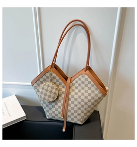 Detail of beige plaid tote bag with brown leather trim and matching round coin purse