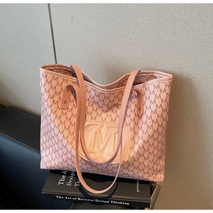Close-up of pink PU leather tote bag with M letter prints and embossed round logo