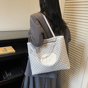 White monogram tote bag with grey M pattern and round embossed logo for women