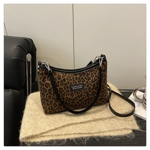 Detail of leopard print shoulder bag with black leather trim and silver metal hardware