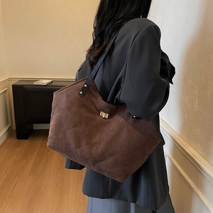 Brown quilted suede tote bag with gold twist lock and black leather shoulder strap
