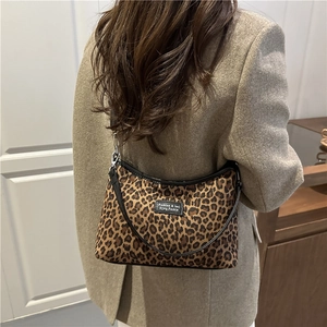 Chic leopard print faux fur half-moon shoulder bag styled with an oversized blazer
