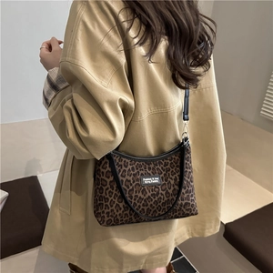 Chic leopard print crossbody bag with fashion tag styled on a vintage trench coat