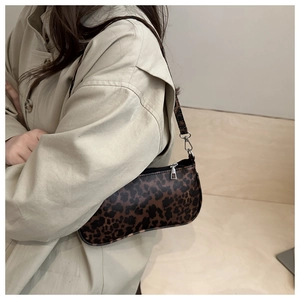 Close-up of leopard print baguette bag texture and silver metal buckle details