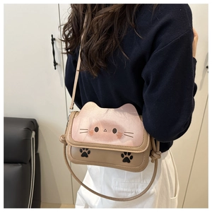 Detail of the cat-shaped crossbody bag featuring a cat head flap and paw cut-out design