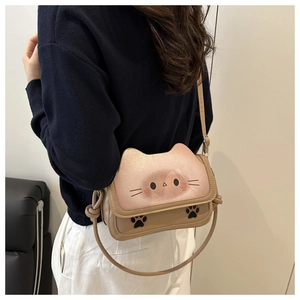 Close-up of cute cat-themed crossbody bag with pink gradient face and paw prints