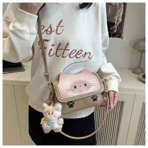 Cat-shaped crossbody bag with pink ears and cute paw prints, featuring a plush bear charm