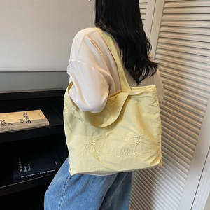 Fashionable large pale yellow tote bag with embroidery for women in casual daily style
