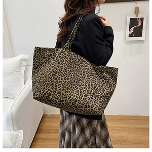 Detail of a large leopard print tote bag with long shoulder straps for daily use