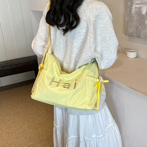 Fashionable bright yellow canvas tote bag with adjustable shoulder strap for women