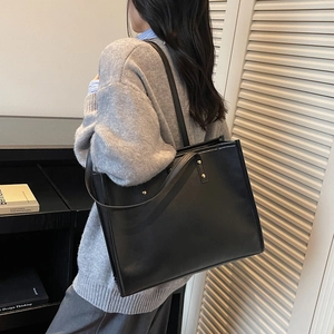 Classic black leather tote bag for women shown as a stylish shoulder bag for daily use