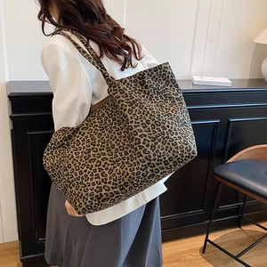 Large leopard print tote bag with brown pattern shown on model for a stylish casual look