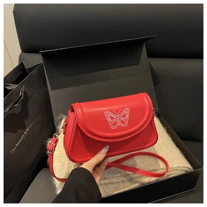 Detail of red PU leather square bag featuring elegant white butterfly embroidery pattern