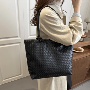 Minimalist black woven leather tote bag with Intrecciato pattern for everyday commute
