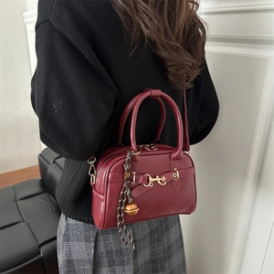Vintage wine red leather crossbody bag with gold horsebit hardware shown on model