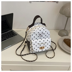 Chic mini polka dot backpack with cat illustration and elegant gold chain strap detail