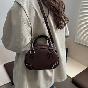 Chic dark brown faux suede bowling bag with silver rivets and adjustable shoulder strap