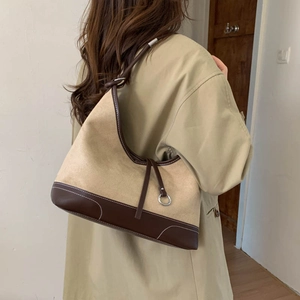 Retro patchwork suede tote bag with brown leather trim and shoulder strap in home setting